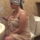 A plump girl who looks like she just got out of the shower sits on a toilet while farting repeatedly and pissing. We are not certain if the farts are genuine. Over 4 minutes.